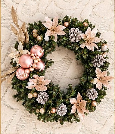 Handmade Christmas wreath with blush poinsettias, pinecones and gold ornaments