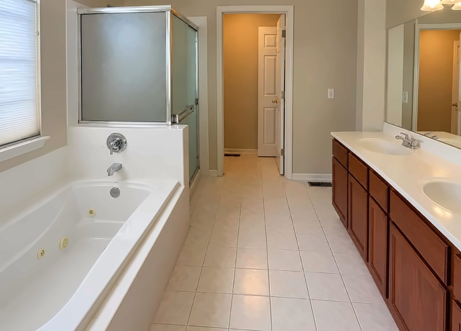 Before (composite from reference photos): a dated primary bathroom with a jetted tub and dark cabinetry