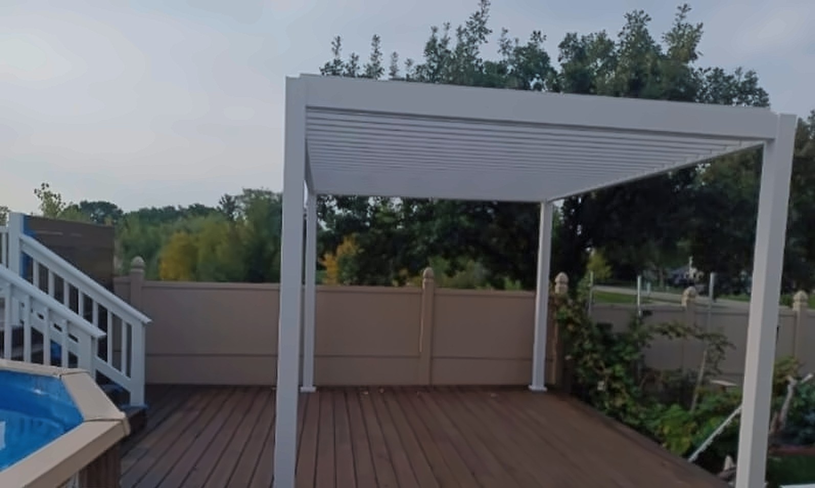 Before: a bare deck with a plain aluminum pergola