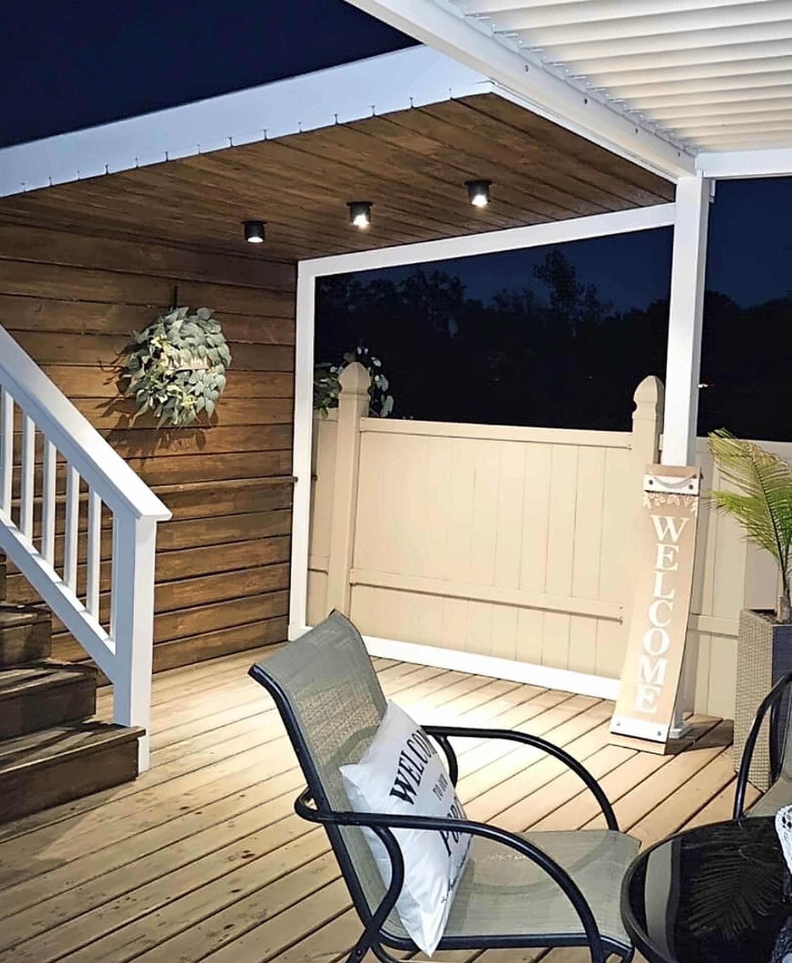 After: the same corner finished with a stained wood accent wall and layered lighting