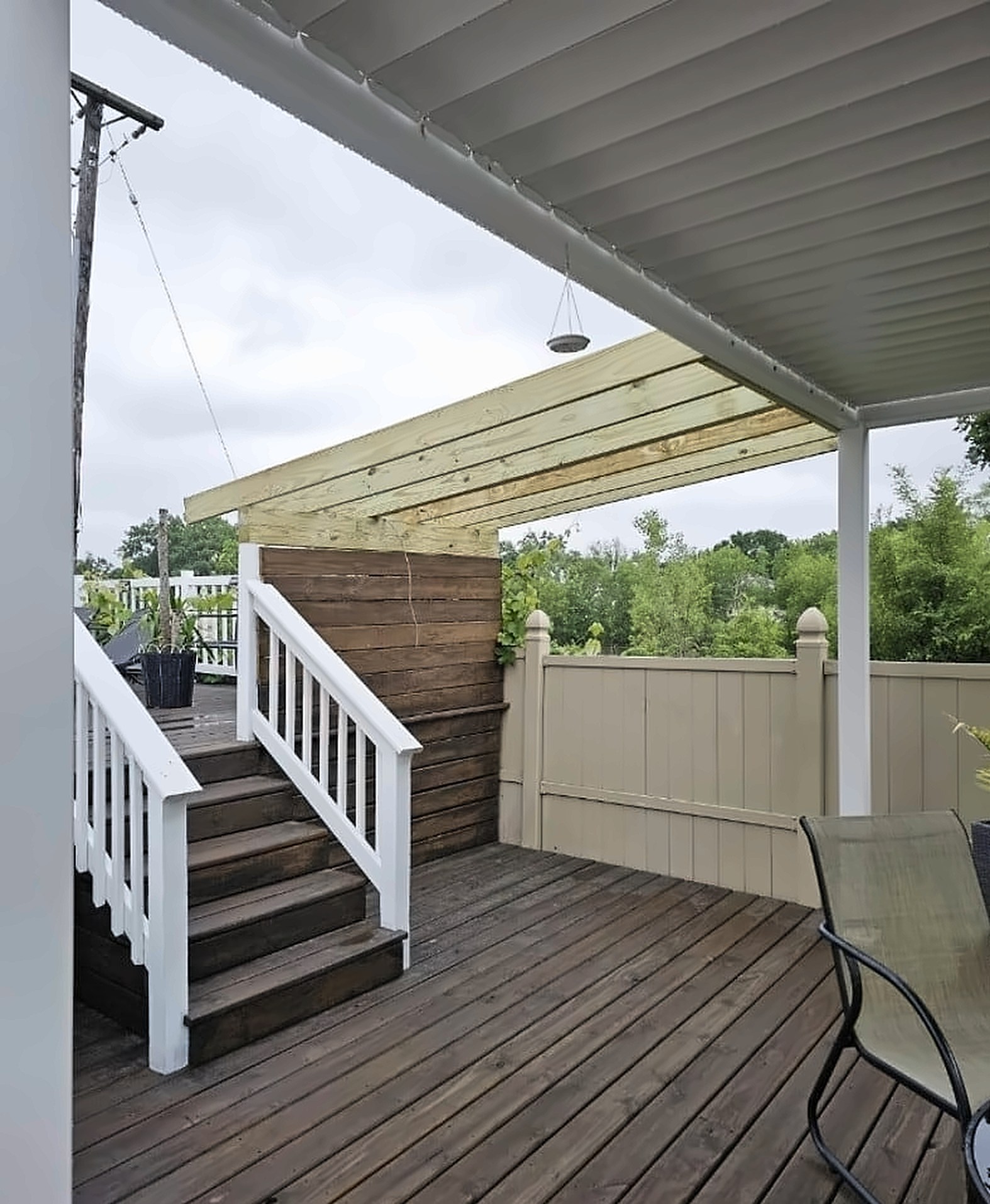 Before: an unfinished deck corner with plain wood framing
